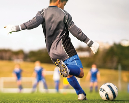 Young boy playing soccer