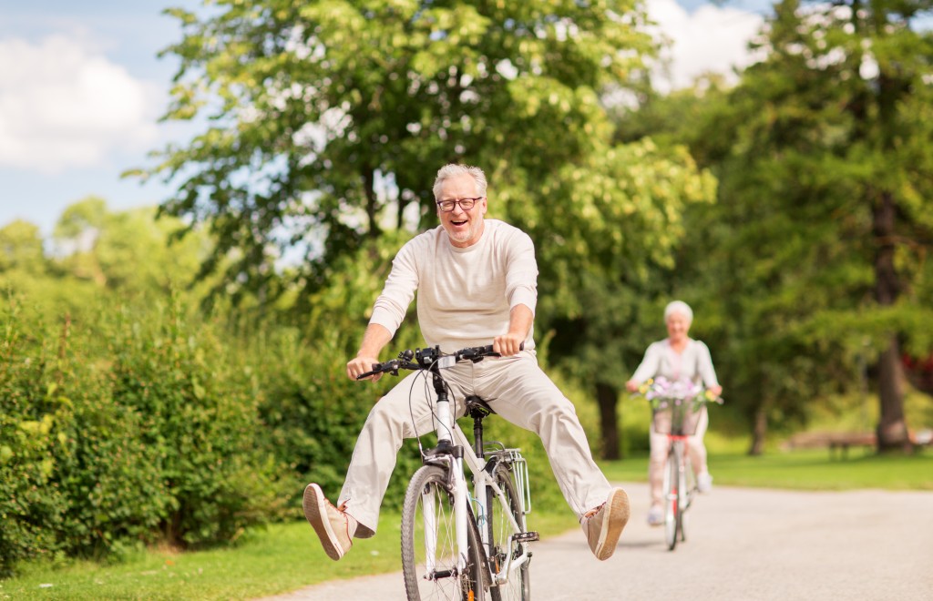 older_couple_riding_bicycles_in_the_park